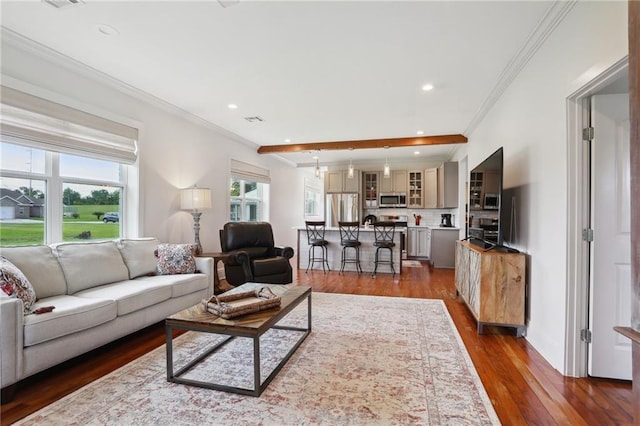 living room featuring dark wood-style flooring, visible vents, crown molding, and recessed lighting