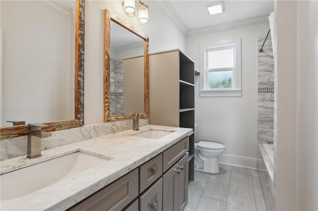 full bath featuring double vanity, ornamental molding, a sink, and baseboards