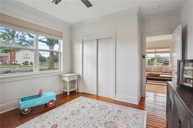 bedroom featuring crown molding, baseboards, and wood finished floors