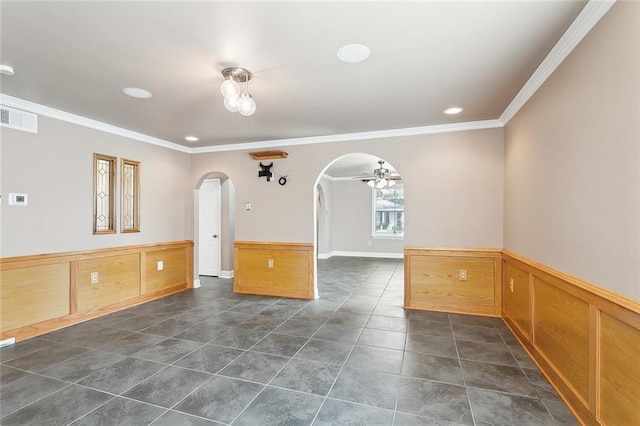 unfurnished room featuring ceiling fan and ornamental molding