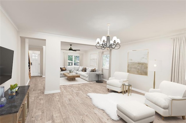 living room featuring ceiling fan with notable chandelier, light wood-type flooring, and crown molding