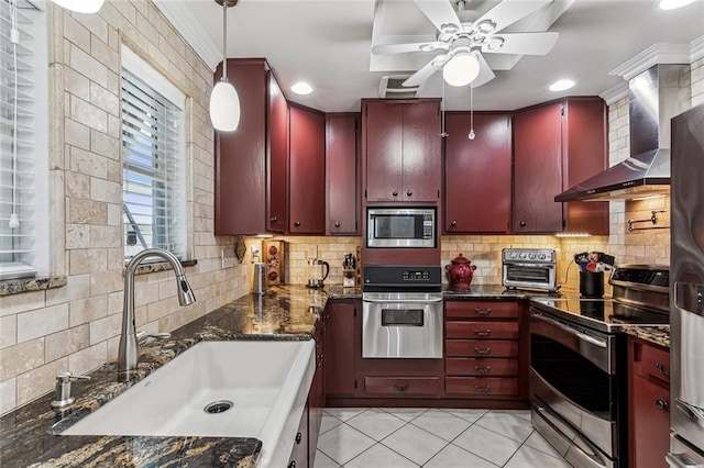 kitchen featuring appliances with stainless steel finishes, decorative backsplash, sink, and wall chimney exhaust hood