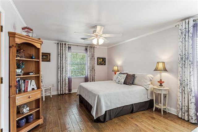 bedroom with ceiling fan, ornamental molding, and hardwood / wood-style flooring