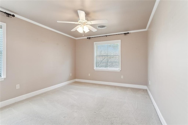 carpeted spare room featuring ceiling fan and ornamental molding