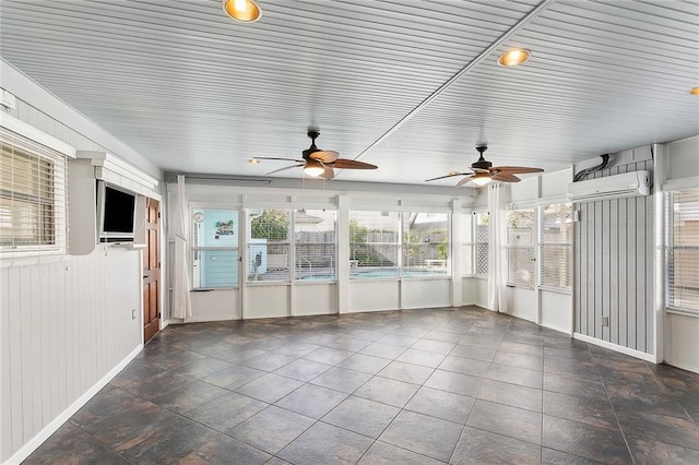 unfurnished sunroom featuring a wall unit AC