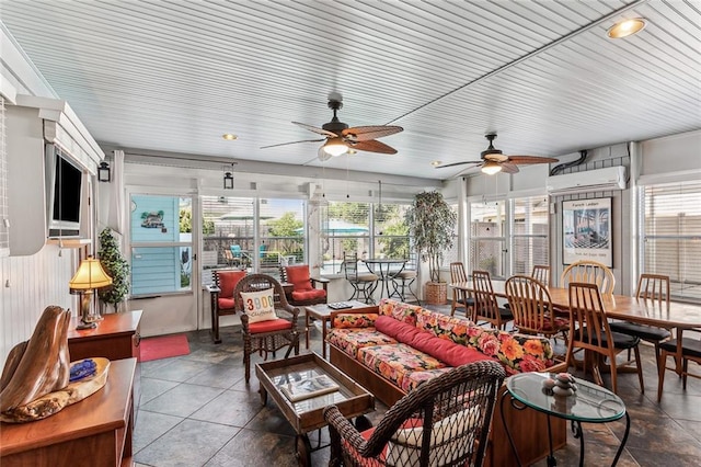 sunroom / solarium with ceiling fan, a wealth of natural light, and a wall unit AC