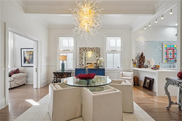 dining area with a wealth of natural light, a chandelier, and wood-type flooring