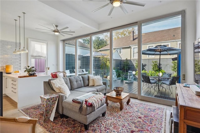 sunroom / solarium with plenty of natural light and ceiling fan