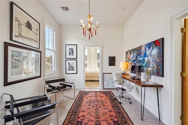 office area featuring hardwood / wood-style flooring and a chandelier