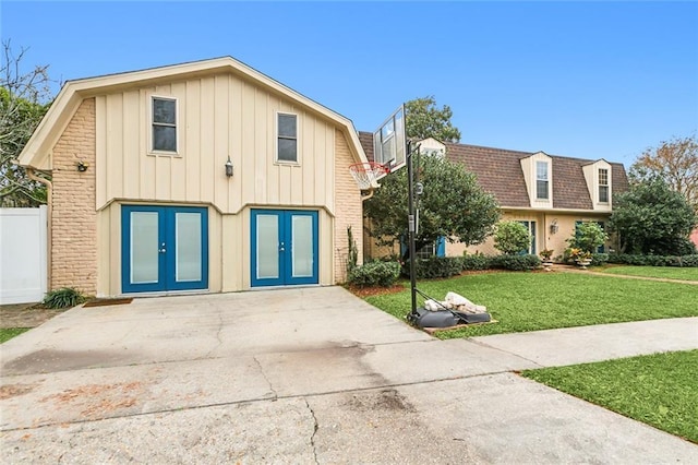 view of front of property with french doors and a front yard