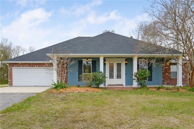 view of front of property with a front yard and a garage