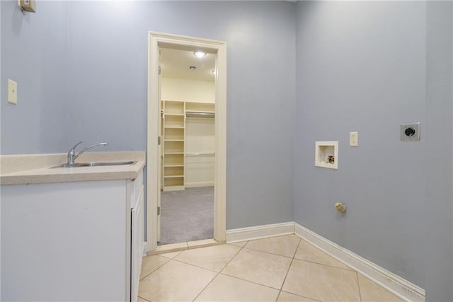 washroom with light tile patterned flooring, washer hookup, electric dryer hookup, and sink