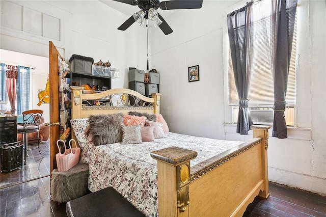 bedroom with ceiling fan and dark wood-type flooring