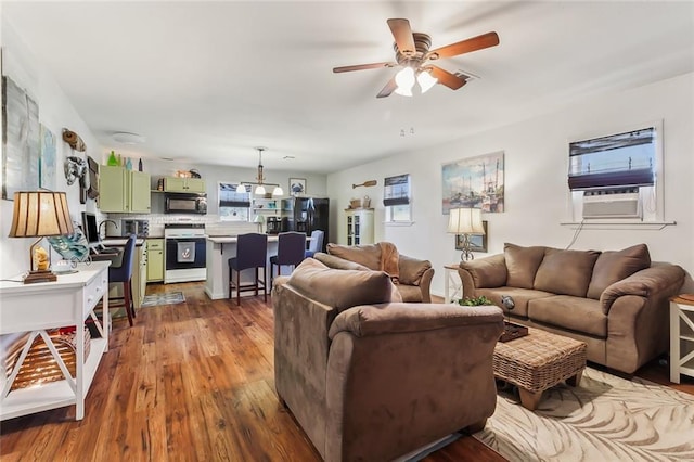 living room featuring ceiling fan, cooling unit, and wood-type flooring