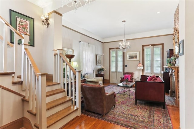 living room featuring hardwood / wood-style flooring and an inviting chandelier