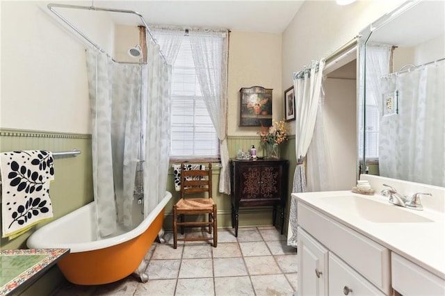 bathroom with a healthy amount of sunlight, shower / tub combo with curtain, and vanity