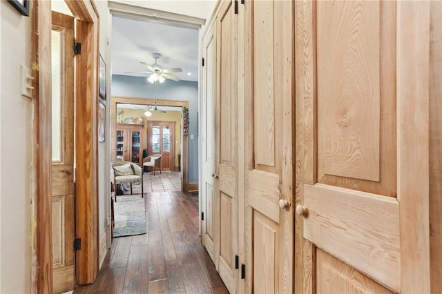 hall featuring a barn door and dark hardwood / wood-style flooring