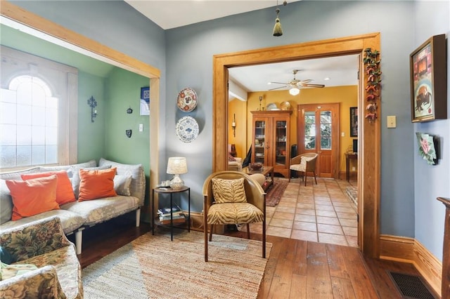 living area featuring ceiling fan and light hardwood / wood-style floors