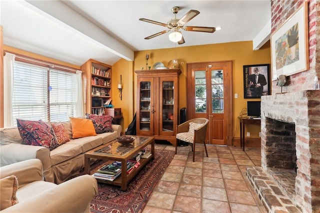 living room with a fireplace, lofted ceiling with beams, and ceiling fan