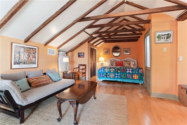 living room with lofted ceiling with beams and light hardwood / wood-style floors