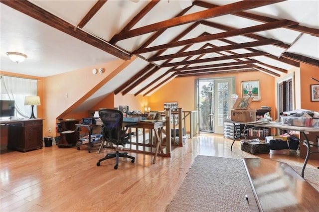 home office with lofted ceiling with beams and light hardwood / wood-style floors