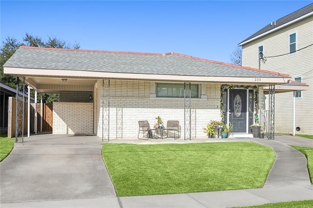 view of front of property featuring a front lawn and a carport