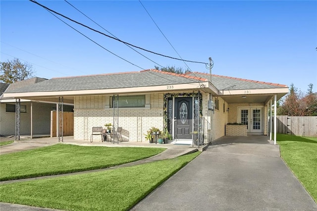 ranch-style home featuring a carport and a front lawn