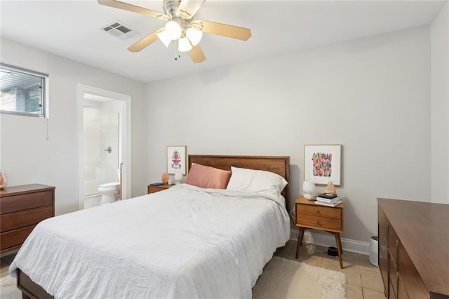 tiled bedroom featuring ensuite bath and ceiling fan