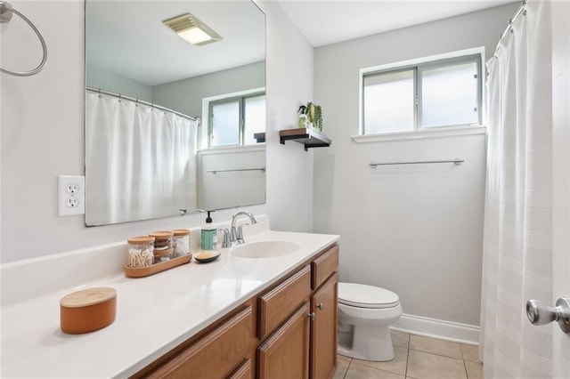 bathroom featuring tile patterned flooring, vanity, and toilet