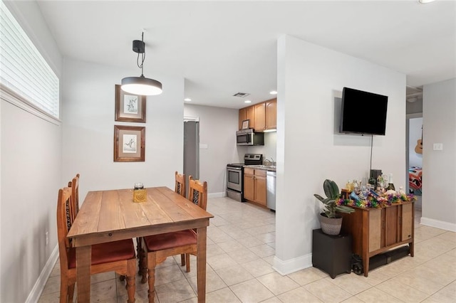 dining space with sink and light tile patterned flooring