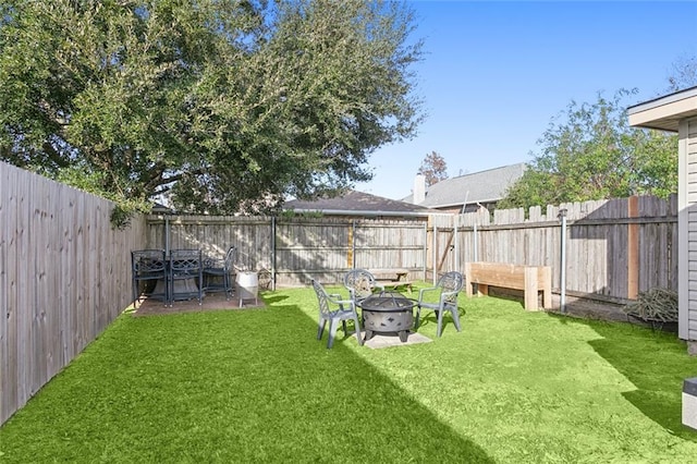 view of yard with an outdoor fire pit