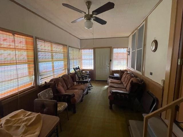 carpeted living room with ceiling fan