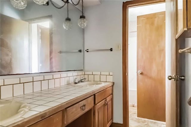 bathroom with vanity and backsplash