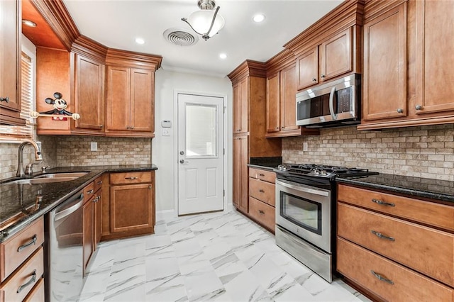 kitchen featuring backsplash, dark stone countertops, sink, and stainless steel appliances