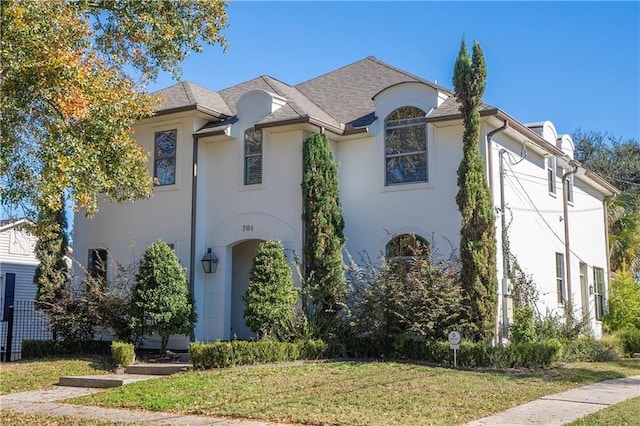 french provincial home with a front yard