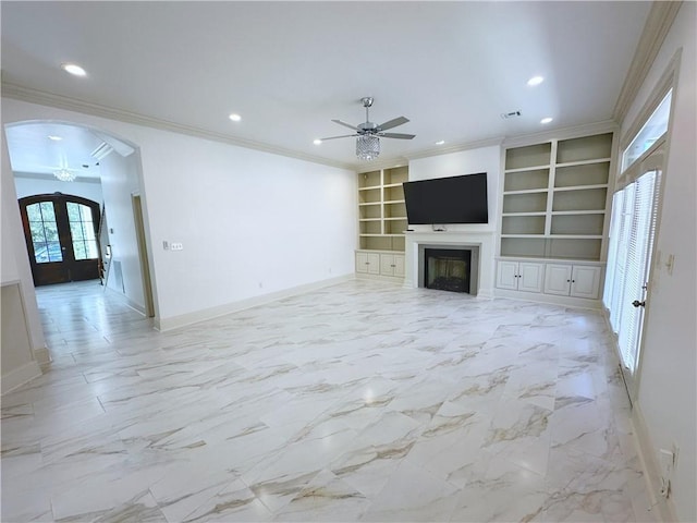 unfurnished living room featuring ceiling fan, built in features, french doors, and ornamental molding