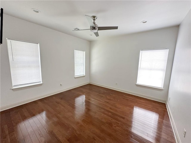 empty room with ceiling fan and dark wood-type flooring