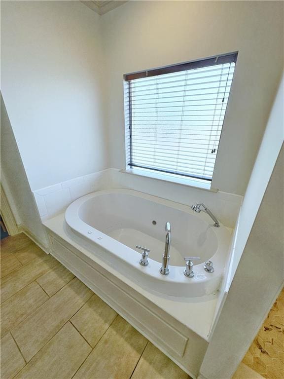 bathroom with tile patterned flooring and a washtub