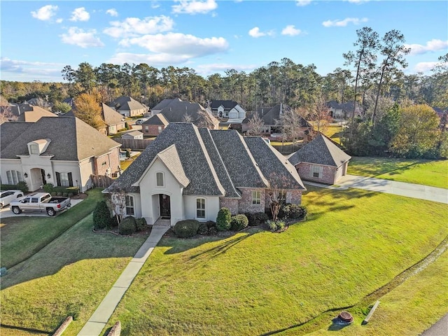 524 Belle Pointe Loop, Madisonville, LA 70447 - view of front of house featuring a residential view, a front lawn, and stucco siding