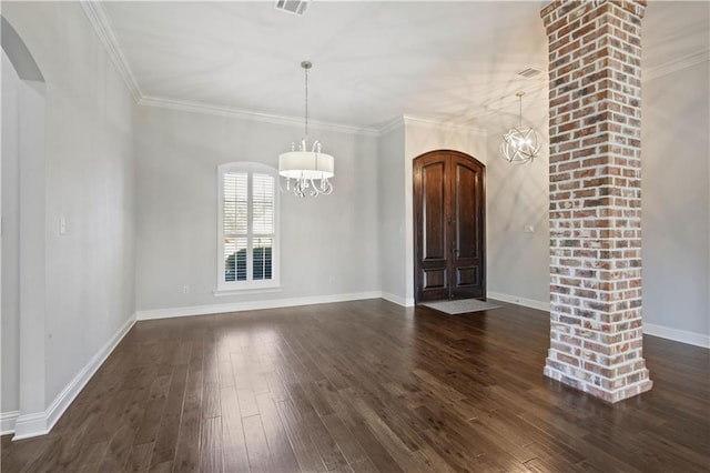 524 Belle Pointe Loop, Madisonville, LA 70447 - foyer entrance featuring arched walkways, a chandelier, dark wood finished floors, baseboards, and crown molding