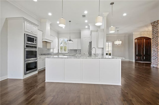 524 Belle Pointe Loop, Madisonville, LA 70447 - kitchen with premium range hood, appliances with stainless steel finishes, tasteful backsplash, dark wood-style floors, and crown molding