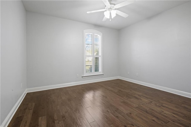 spare room featuring dark hardwood / wood-style flooring and ceiling fan