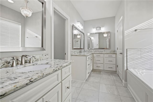 524 Belle Pointe Loop, Madisonville, LA 70447 - full bath with two vanities, a tub, and a chandelier