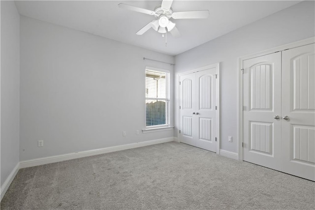 unfurnished bedroom with ceiling fan and light colored carpet