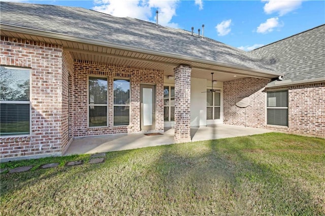 524 Belle Pointe Loop, Madisonville, LA 70447 - back of house with brick siding, a shingled roof, a lawn, and a patio