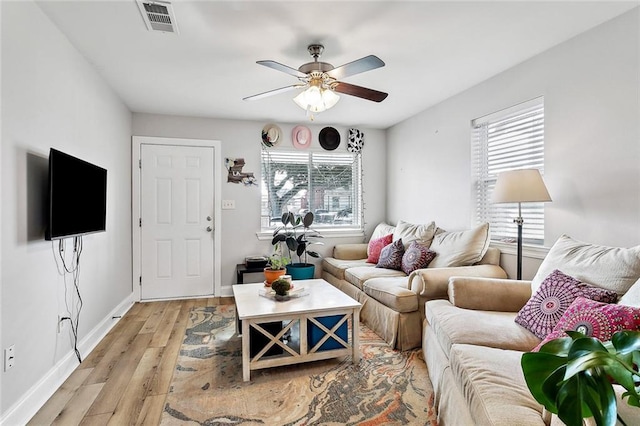 living room with ceiling fan and light wood-type flooring