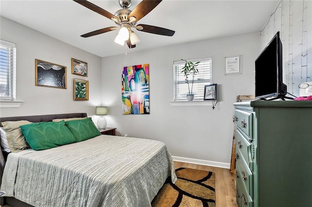 bedroom with ceiling fan and light wood-type flooring