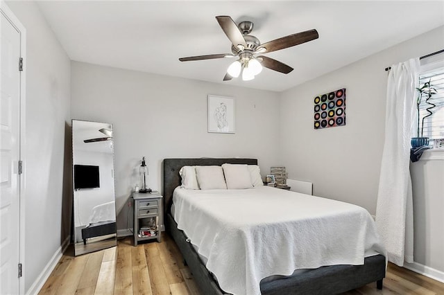 bedroom featuring ceiling fan and light hardwood / wood-style flooring