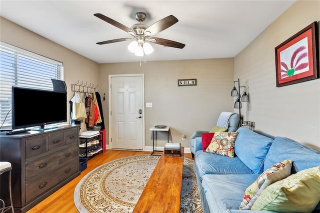 living room featuring ceiling fan and light hardwood / wood-style floors