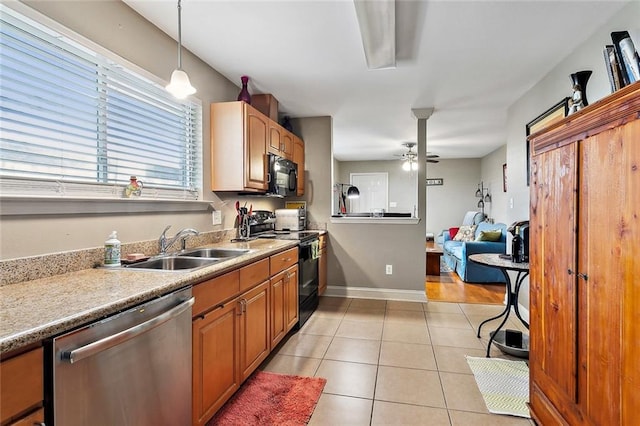 kitchen with ceiling fan, sink, black appliances, light tile patterned floors, and decorative light fixtures